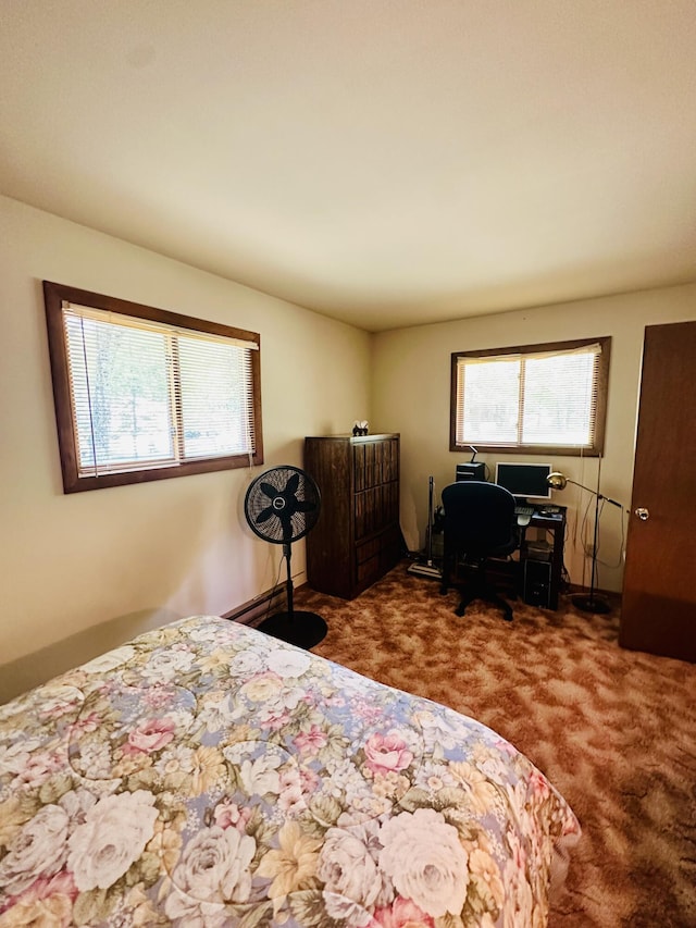 bedroom with multiple windows, carpet flooring, and an office area