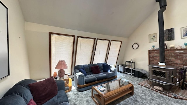 living room with a wood stove, carpet flooring, and high vaulted ceiling