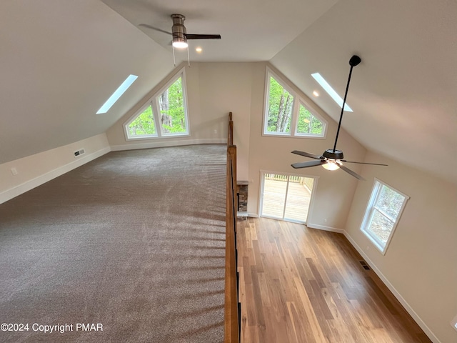 30 Susquehanna Dr, Jim Thorpe, PA 18229 - unfurnished living room with a skylight, a ceiling fan, lofted ceiling, plenty of natural light, and wood finished floors