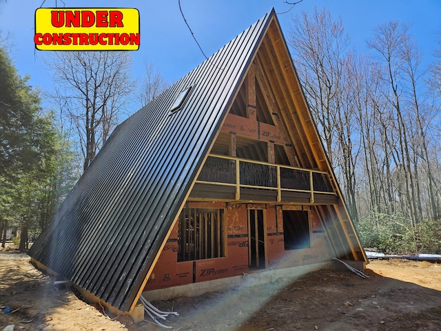 a-frame style home featuring a standing seam roof and metal roof