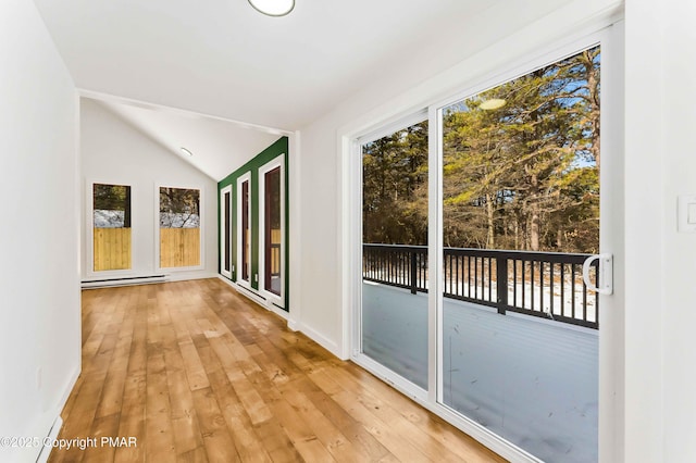 corridor with lofted ceiling, light hardwood / wood-style flooring, and baseboard heating