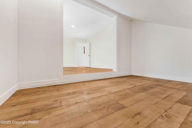 bonus room with hardwood / wood-style flooring and lofted ceiling