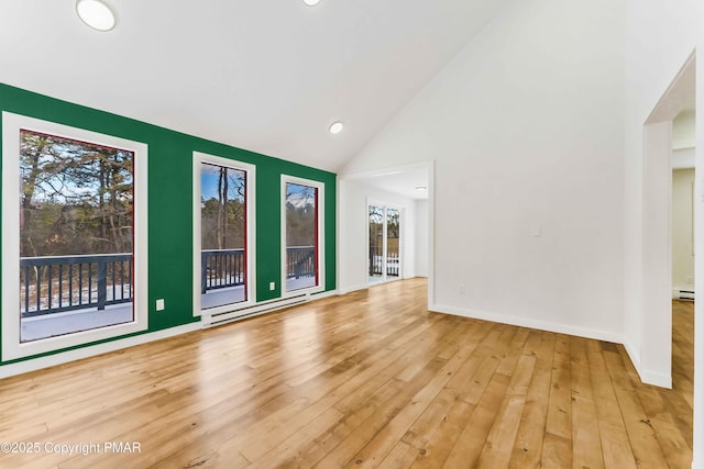 interior space featuring high vaulted ceiling, a baseboard radiator, and light hardwood / wood-style floors