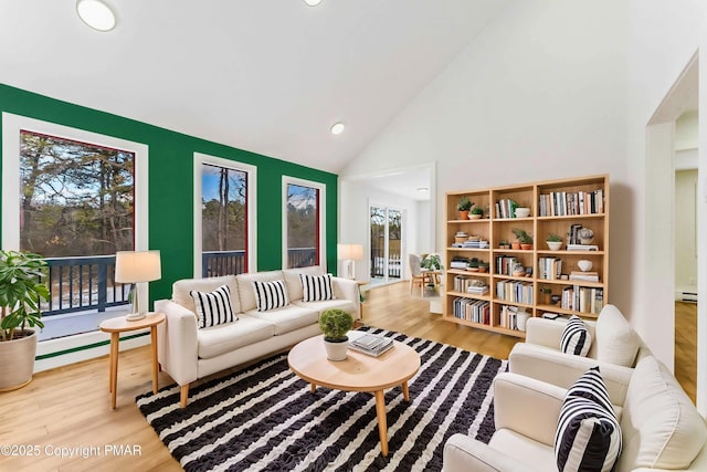 living room featuring recessed lighting, wood finished floors, a baseboard radiator, and high vaulted ceiling