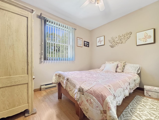 5119 Derby Rd, Tobyhanna, PA 18466 - bedroom featuring a baseboard heating unit, wood finished floors, ceiling fan, and baseboards