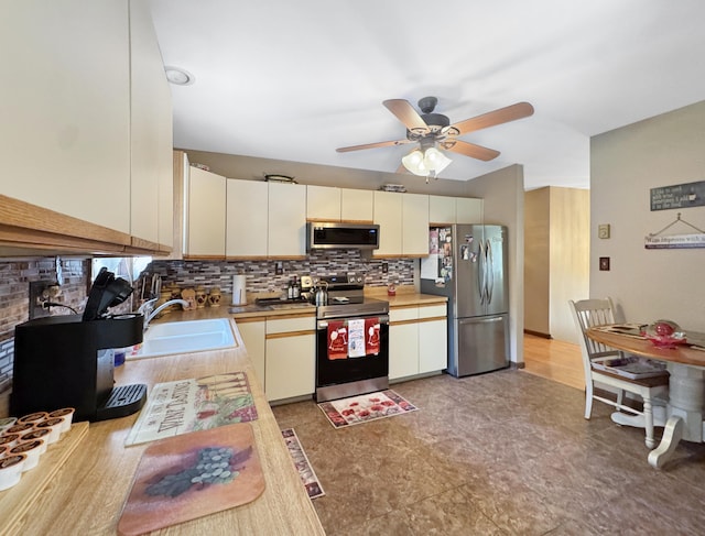 5119 Derby Rd, Tobyhanna, PA 18466 - kitchen featuring appliances with stainless steel finishes, a sink, tasteful backsplash, ceiling fan, and light countertops