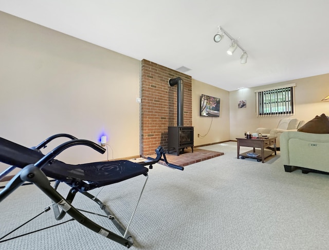 5119 Derby Rd, Tobyhanna, PA 18466 - exercise room with a wood stove, carpet floors, track lighting, and baseboards