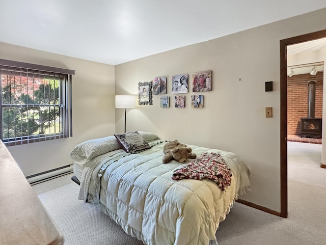 5119 Derby Rd, Tobyhanna, PA 18466 - bedroom featuring baseboard heating, carpet flooring, a wood stove, and baseboards