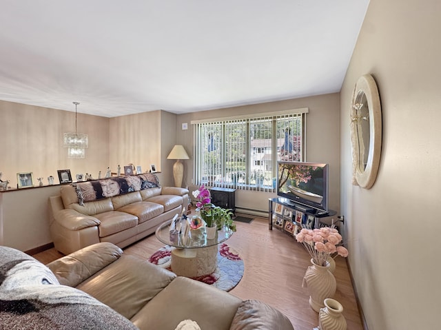 5119 Derby Rd, Tobyhanna, PA 18466 - living room with a chandelier, wood finished floors, and a baseboard radiator