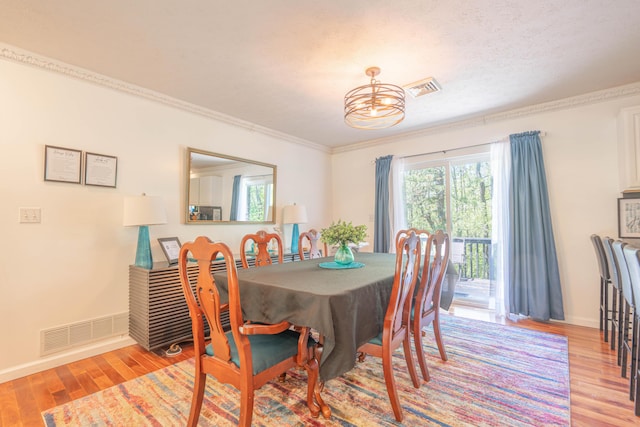 165 Stillwater Dr, Pocono Summit, PA 18346 - dining area featuring crown molding, light wood-style floors, and baseboards