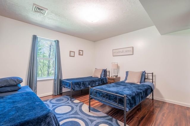 165 Stillwater Dr, Pocono Summit, PA 18346 - bedroom featuring wood finished floors, a textured ceiling, and baseboards