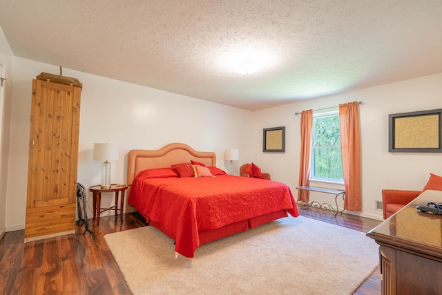 165 Stillwater Dr, Pocono Summit, PA 18346 - bedroom with dark wood-style flooring and a textured ceiling