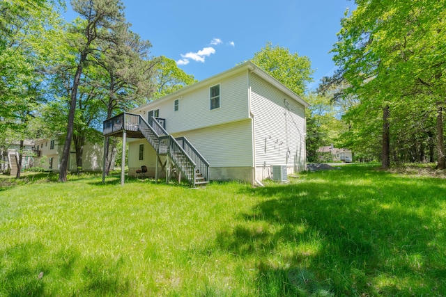 165 Stillwater Dr, Pocono Summit, PA 18346 - rear view of property featuring stairs, a wooden deck, a lawn, and central AC unit