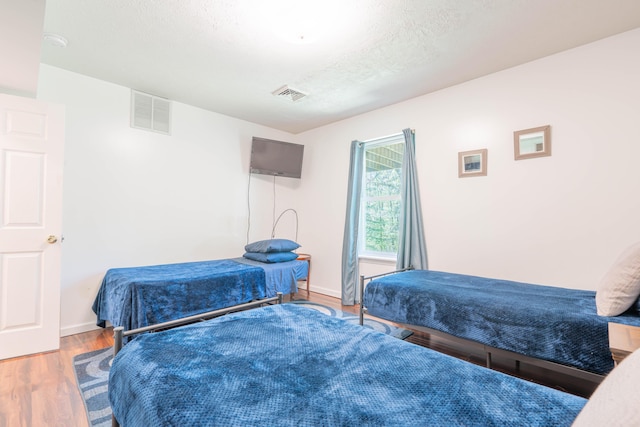 165 Stillwater Dr, Pocono Summit, PA 18346 - bedroom featuring wood finished floors, baseboards, and a textured ceiling