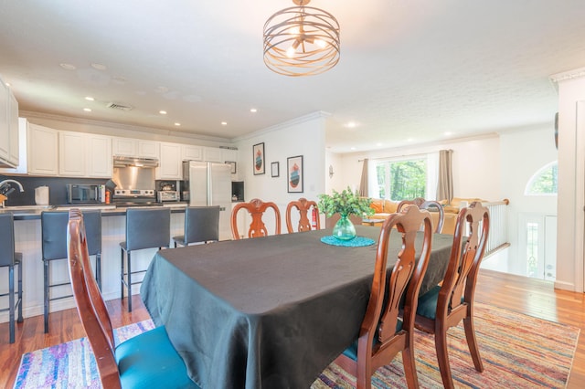165 Stillwater Dr, Pocono Summit, PA 18346 - dining room with wood finished floors, recessed lighting, and ornamental molding