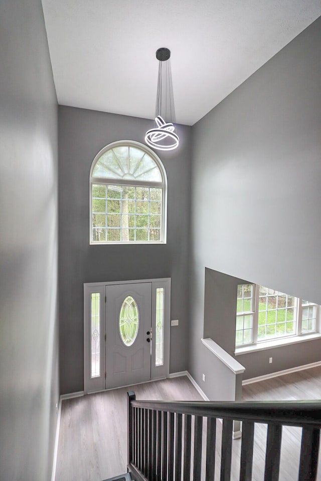 302 Leaf St, Tobyhanna, PA 18466 - foyer with wood finished floors, a chandelier, plenty of natural light, and a high ceiling