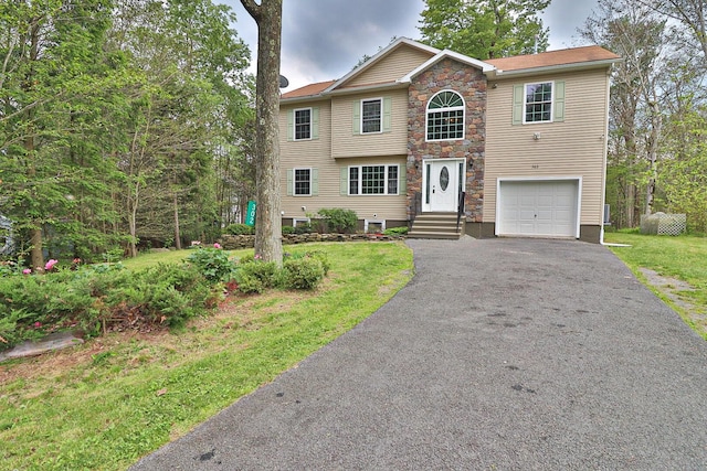 302 Leaf St, Tobyhanna, PA 18466 - view of front of home with driveway, a garage, stone siding, and a front lawn