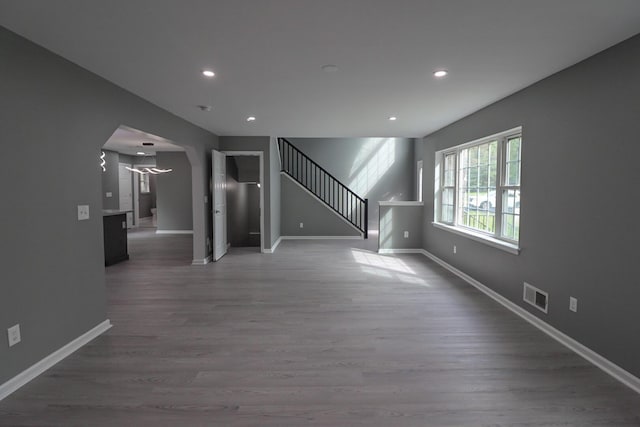 302 Leaf St, Tobyhanna, PA 18466 - unfurnished living room with arched walkways, stairs, wood finished floors, and recessed lighting