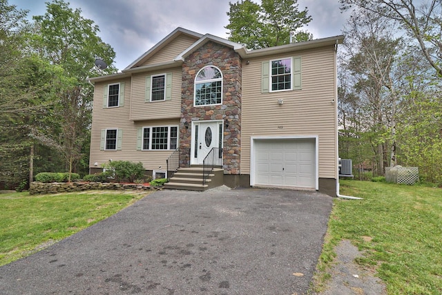 302 Leaf St, Tobyhanna, PA 18466 - view of front of house with driveway, a garage, a front yard, and stone siding