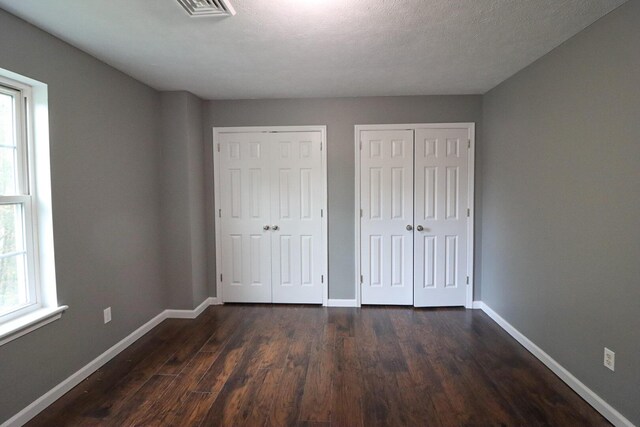 302 Leaf St, Tobyhanna, PA 18466 - unfurnished bedroom featuring two closets and dark wood finished floors