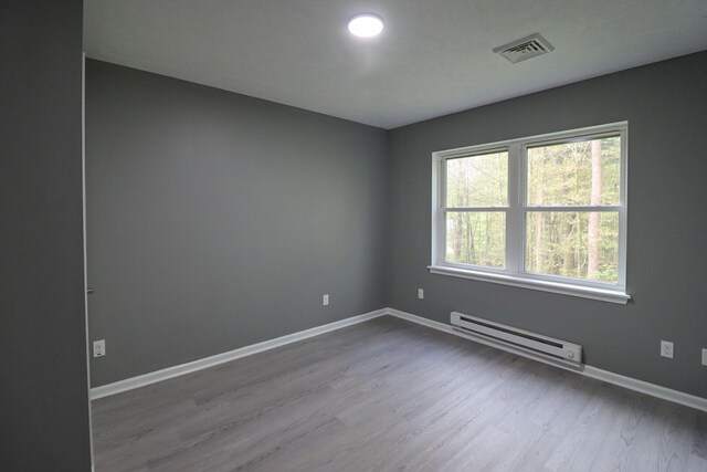 302 Leaf St, Tobyhanna, PA 18466 - unfurnished room featuring baseboard heating and wood finished floors