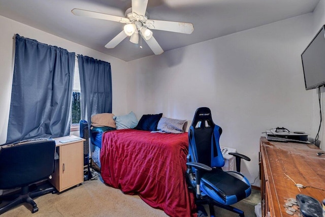 bedroom featuring light colored carpet and a ceiling fan