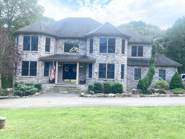 5132 Pocono Park Ln, Swiftwater, PA 18370 - view of front of property featuring a porch, a front lawn, and stone siding