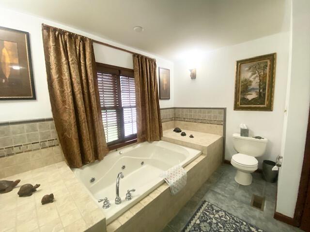 5132 Pocono Park Ln, Swiftwater, PA 18370 - bathroom featuring tile patterned flooring and a tub with jets