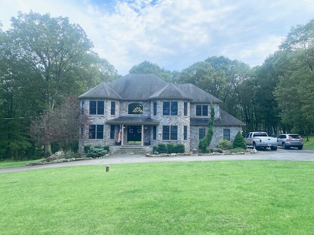 5132 Pocono Park Ln, Swiftwater, PA 18370 - view of front of property featuring stone siding and a front lawn