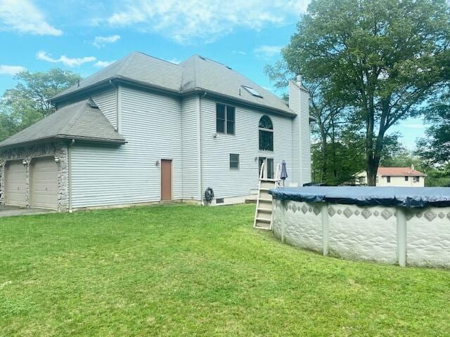 5132 Pocono Park Ln, Swiftwater, PA 18370 - back of property featuring a chimney, a lawn, and a covered pool
