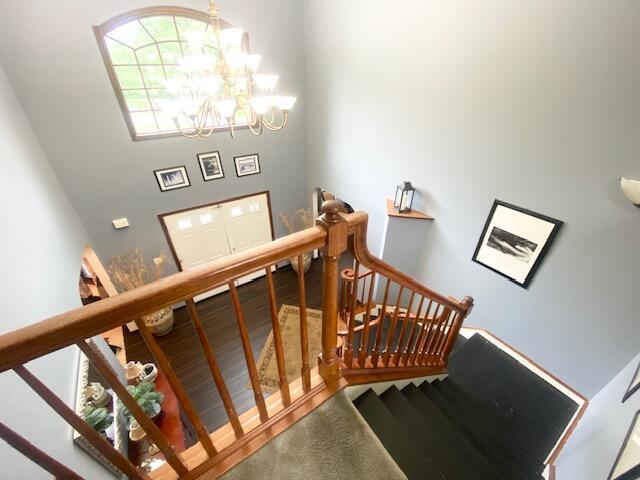 5132 Pocono Park Ln, Swiftwater, PA 18370 - stairway featuring a chandelier and finished concrete floors