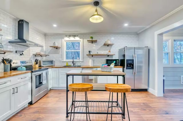 3312 Black Cherry Ct, Long Pond, PA 18334 - kitchen with butcher block counters, a sink, wall chimney exhaust hood, backsplash, and appliances with stainless steel finishes