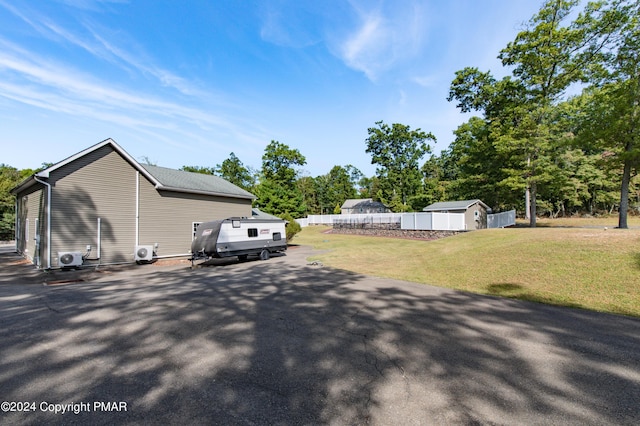 view of yard with an outdoor structure and fence