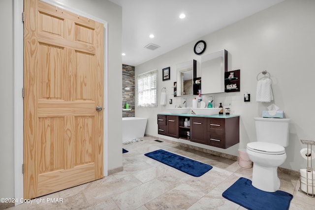 full bath with visible vents, toilet, a freestanding bath, vanity, and recessed lighting