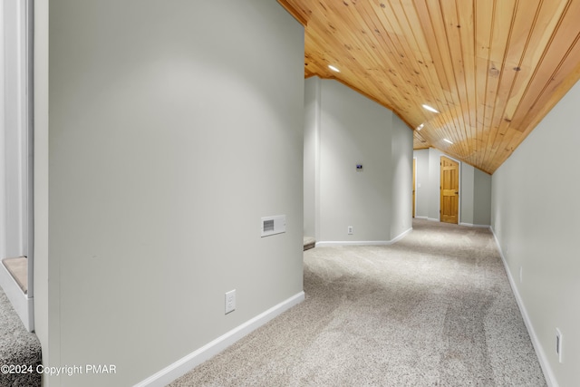 interior space with carpet floors, wooden ceiling, baseboards, and lofted ceiling