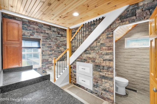 bathroom featuring toilet, wood ceiling, and visible vents