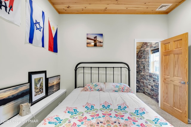 bedroom with carpet floors, wooden ceiling, and visible vents