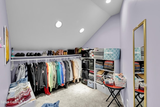 walk in closet featuring lofted ceiling and carpet flooring