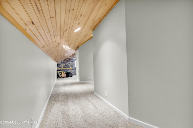 hallway with baseboards, lofted ceiling, wood ceiling, carpet, and recessed lighting