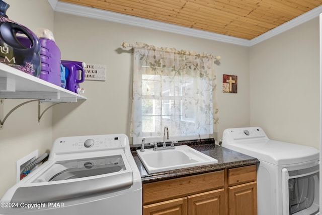 laundry room with crown molding, washer and clothes dryer, wooden ceiling, a sink, and laundry area