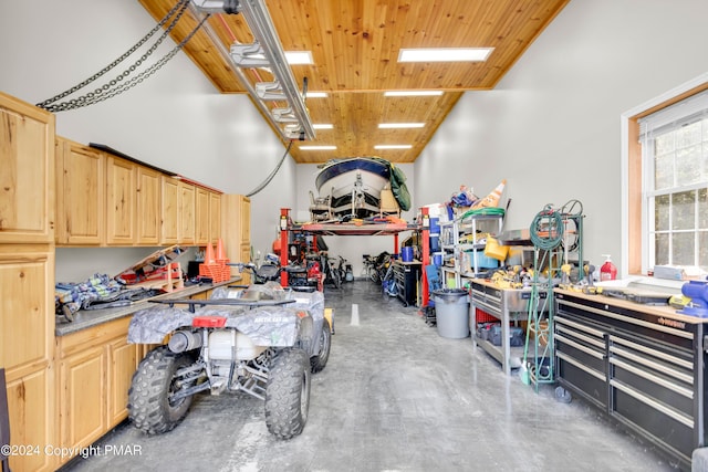 garage featuring wood ceiling and a workshop area