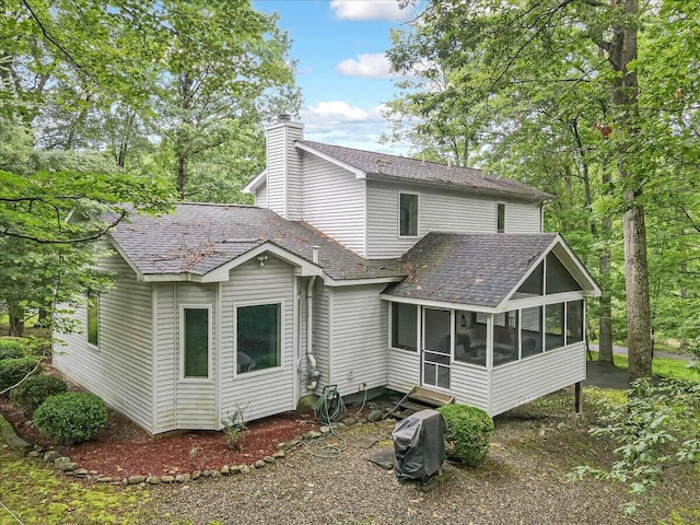 106 Legends Ct, East Stroudsburg, PA 18302 - back of property featuring a sunroom, a chimney, and a shingled roof