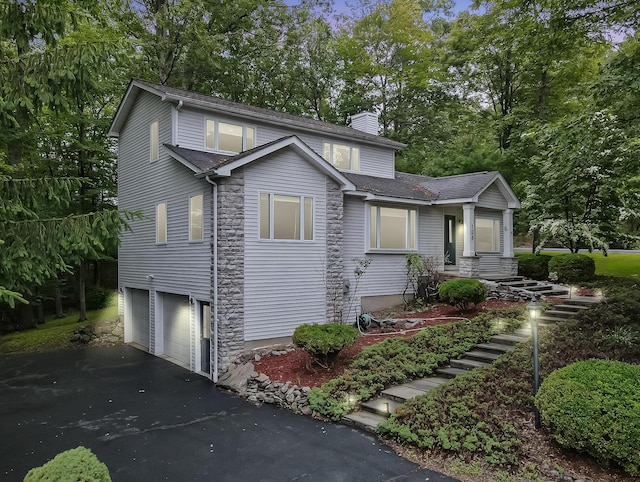 106 Legends Ct, East Stroudsburg, PA 18302 - traditional-style house with a chimney, a garage, driveway, and stone siding
