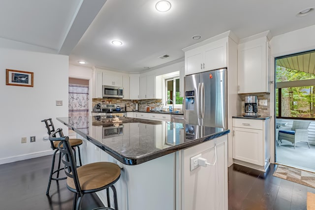106 Legends Ct, East Stroudsburg, PA 18302 - kitchen with stainless steel appliances, white cabinetry, tasteful backsplash, recessed lighting, and a center island