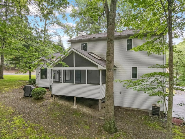 106 Legends Ct, East Stroudsburg, PA 18302 - rear view of property with a chimney, a sunroom, and a shingled roof