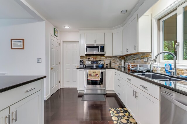 106 Legends Ct, East Stroudsburg, PA 18302 - kitchen with appliances with stainless steel finishes, decorative backsplash, white cabinetry, recessed lighting, and dark wood-type flooring
