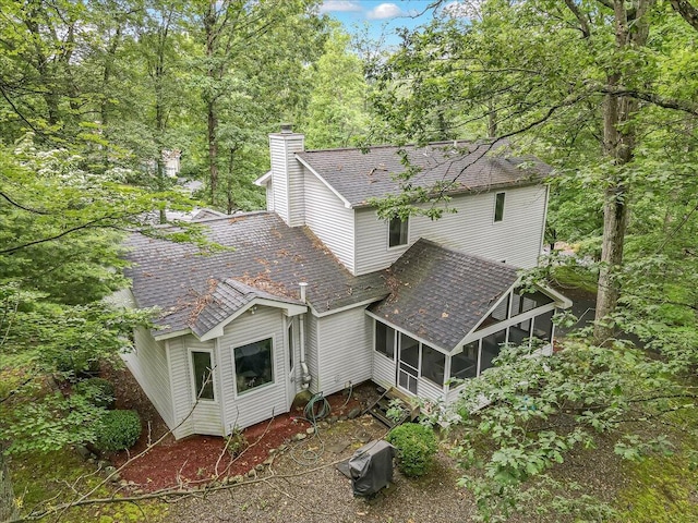 106 Legends Ct, East Stroudsburg, PA 18302 - back of property featuring a sunroom, roof with shingles, and a chimney