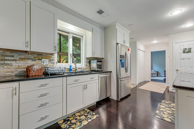 106 Legends Ct, East Stroudsburg, PA 18302 - kitchen with stainless steel appliances, backsplash, white cabinetry, dark wood-style floors, and recessed lighting