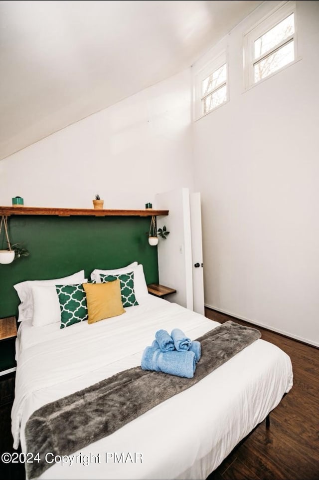 bedroom with wood finished floors and baseboards