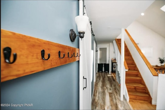 interior details with wood finished floors and a barn door